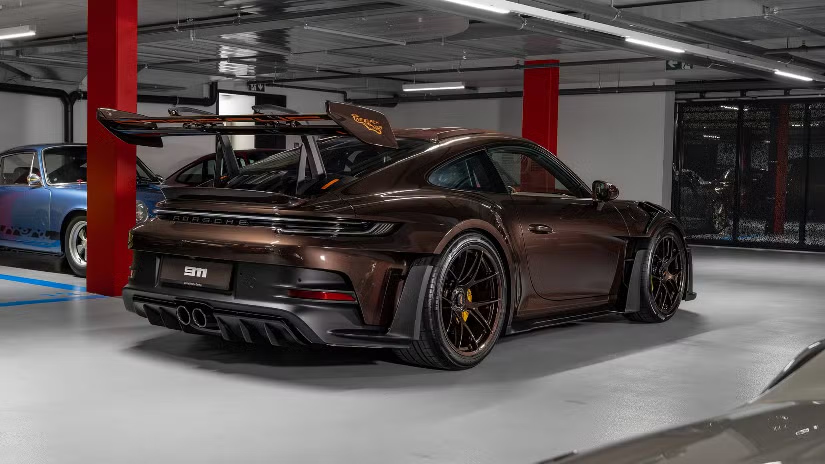 2025-porsche-911-gt3-rs-sonderwunsch-macadamia-brown-exterior-rear-quarter.jpeg