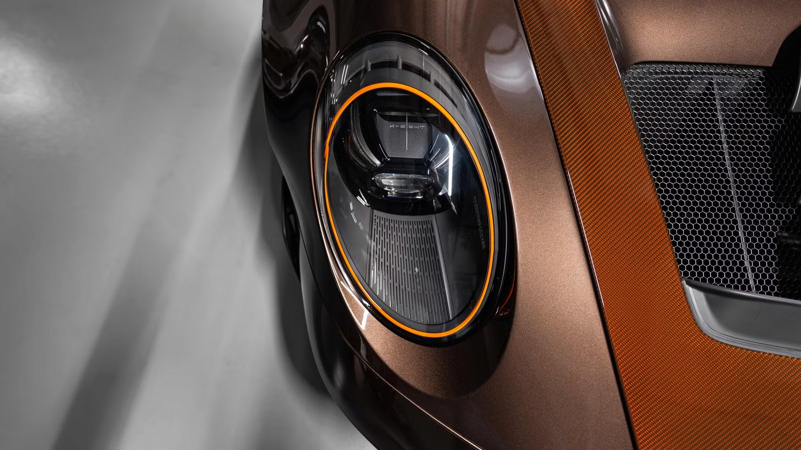 2026-porsche-911-gt3-rs-sonderwunsch-macadamia-brown-exterior-headlight-detail.jpeg