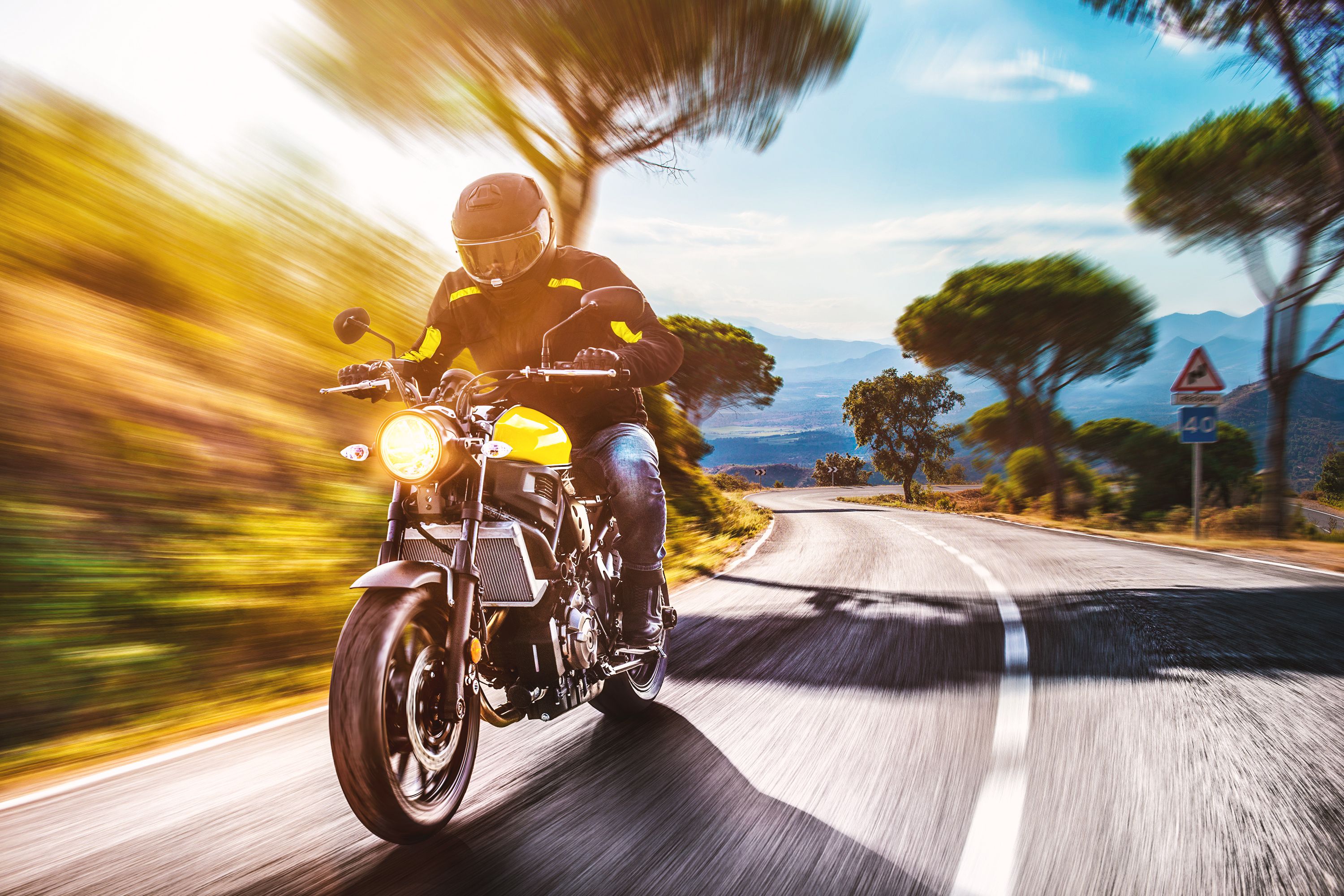 man-riding-motorcycle-on-road-against-sky-688920025-5c339bd4c9e77c0001baaa59.jpg